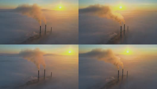 鸟瞰图，在日出时，煤电厂的高管与黑烟向上移动污染的大气。高清在线视频素材下载