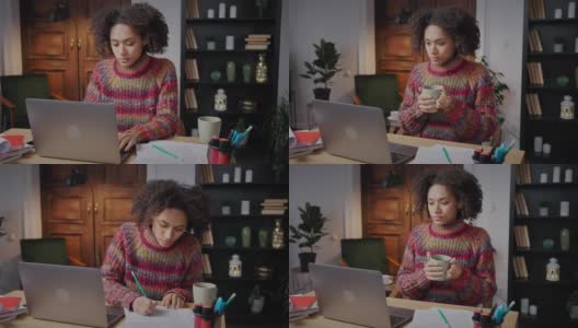 在线教育年轻卷曲的非裔美国妇女做项目研究，做笔记，喝咖啡在家里高清在线视频素材下载
