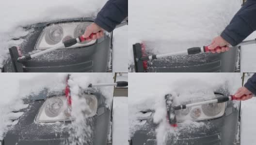 冬天，一名男子拿着刷子在车上清理积雪。早晨，汽车被雪覆盖着高清在线视频素材下载