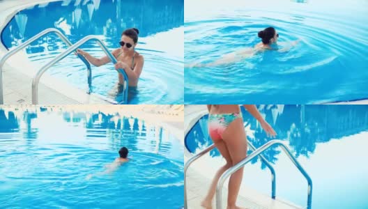 在一个阳光明媚的夏日里，穿着比基尼、戴着墨镜的黑发女子走进游泳池游泳高清在线视频素材下载