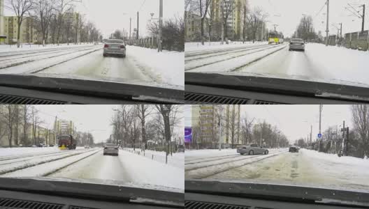 一场大雪过后，汽车载着雪行驶在城市道路上高清在线视频素材下载