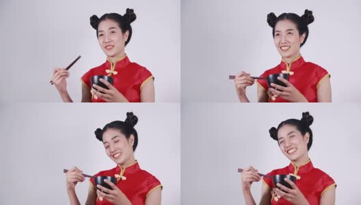 快乐的女人穿着中国旗袍，带着筷子和碗高清在线视频素材下载