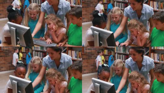 学生和老师在图书馆看电脑高清在线视频素材下载