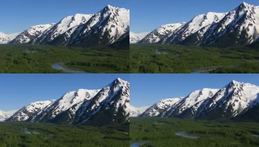 空中拍摄的森林溪流和雪山，阿拉斯加高清在线视频素材下载