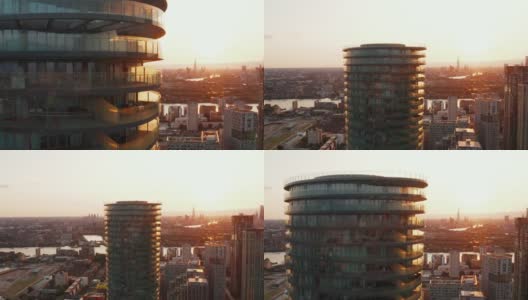 拉回未来圆柱形公寓建筑Arena Tower的镜头，背景是日落的天空。英国伦敦高清在线视频素材下载
