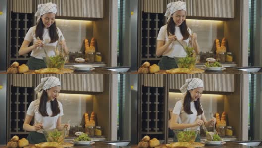 亚洲家庭主妇在厨房柜台准备新鲜蔬菜做沙拉。高清在线视频素材下载