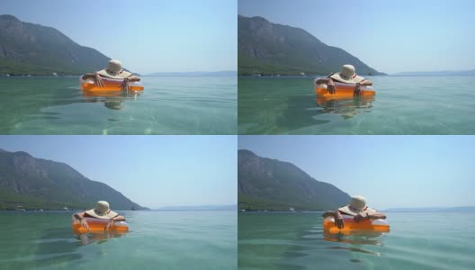 戴着帽子的中年妇女，在海边休息。Marmaris土耳其高清在线视频素材下载