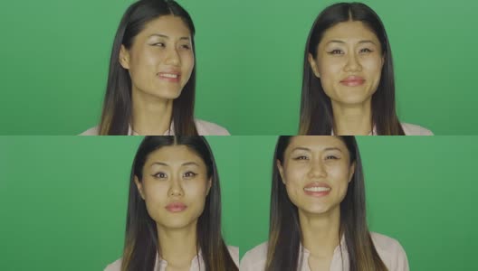 美丽的亚洲女人微笑，在一个绿色屏幕的工作室背景高清在线视频素材下载
