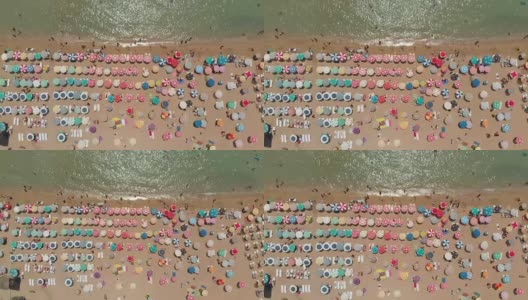 鸟瞰爱琴海海滩上的雨伞高清在线视频素材下载