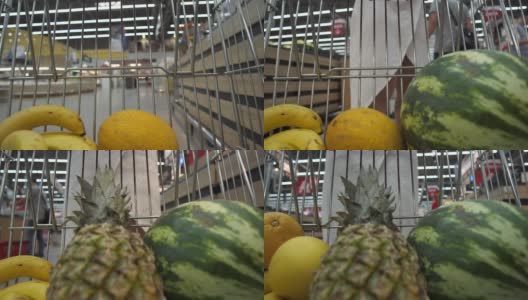 女人把水果放在购物车里高清在线视频素材下载