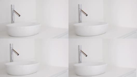 白色洗手盆和水龙头在现代公寓-家庭装饰高清在线视频素材下载