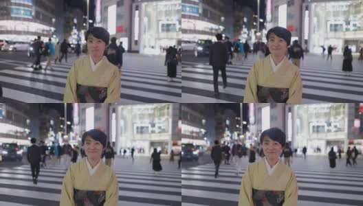 身着和服的日本妇女站在夜间城市的斑马线上高清在线视频素材下载