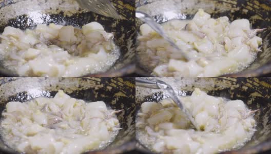 用大蒜和油在平底锅里炒。海鲜和亚洲菜单。高清在线视频素材下载