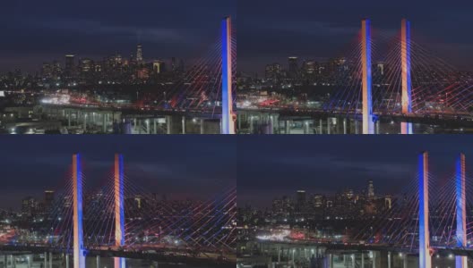 夜深时分，科修斯科大桥上的车流不断变换着颜色，背景是曼哈顿和布鲁克林的远处景色。航拍视频与宽平移摄像机运动。高清在线视频素材下载