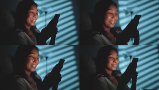 亚洲女性晚上在床上使用智能手机高清在线视频素材下载