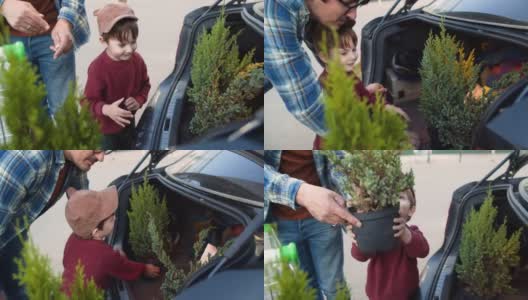 在花园中心购物后，家人把植物放在停车场的车里高清在线视频素材下载