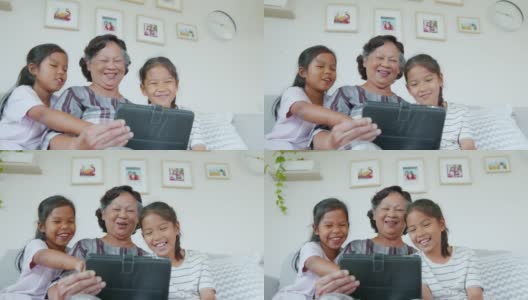 两个孙女一起在客厅里帮奶奶用ipad。高清在线视频素材下载
