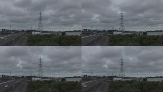 暴风云在高速公路旁的电塔上移动高清在线视频素材下载