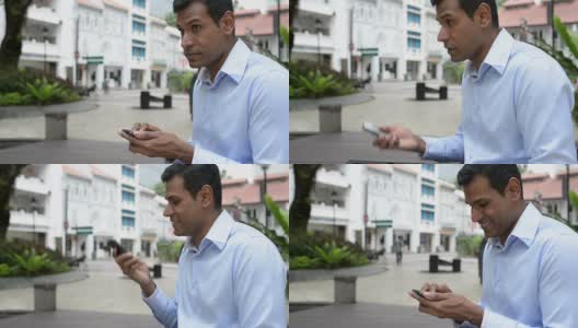 兴高采烈的印度商人在户外发短信高清在线视频素材下载