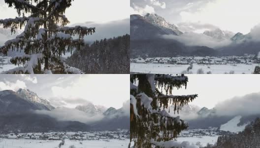 空中覆盖着皑皑白雪的高山峡谷下面的山顶高清在线视频素材下载