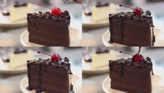 HD:用手把酱汁浇在一块蛋糕上，巧克力蛋糕高清在线视频素材下载
