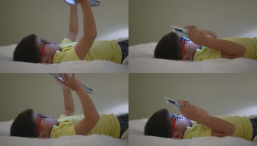 亚洲男孩在数码平板电脑上玩社交媒体。成瘾的概念高清在线视频素材下载