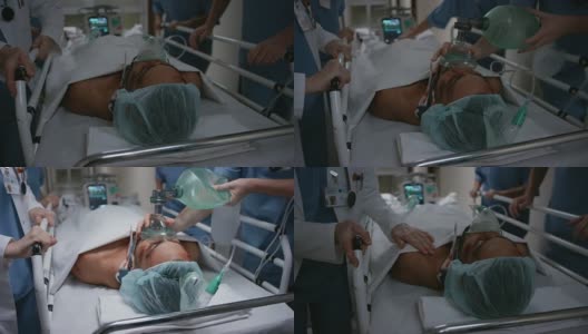 一个医疗小组为一位男性病人手动通气送进手术室高清在线视频素材下载