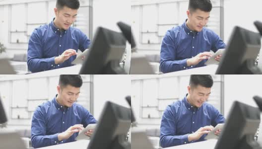 年轻的亚洲男子使用数字平板电脑高清在线视频素材下载
