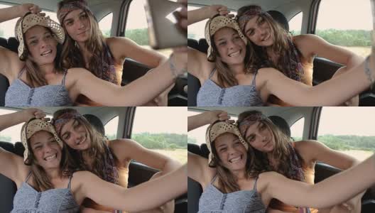 两姐妹在车上用手机自拍高清在线视频素材下载