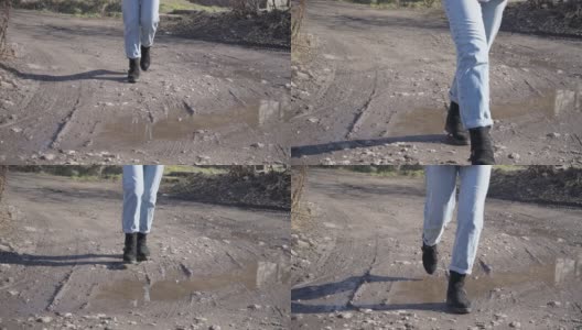 穿牛仔裤的女孩走在泥泞中慢动作高清在线视频素材下载