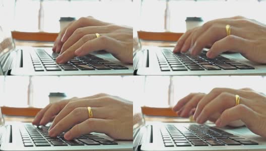 在家工作，用笔记本电脑写博客。咖啡店里男性的手在敲击键盘。高清在线视频素材下载