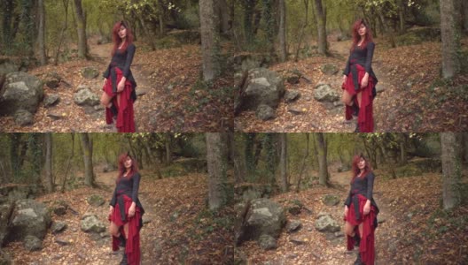 野性非凡的女人在金秋的树林里摆姿势，神秘的人物在森林里旅行高清在线视频素材下载