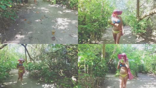 马尔代夫，一名金发碧眼的嬉皮女子边喝椰子汁边徒步探索丛林高清在线视频素材下载
