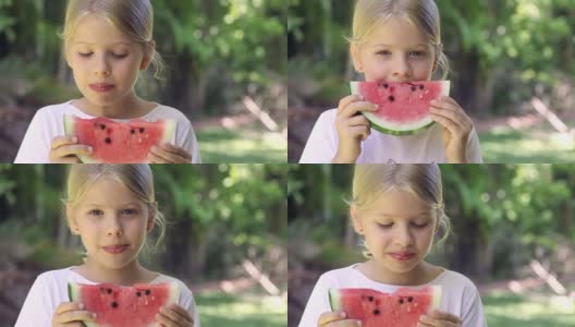 小女孩微笑着在户外吃西瓜高清在线视频素材下载