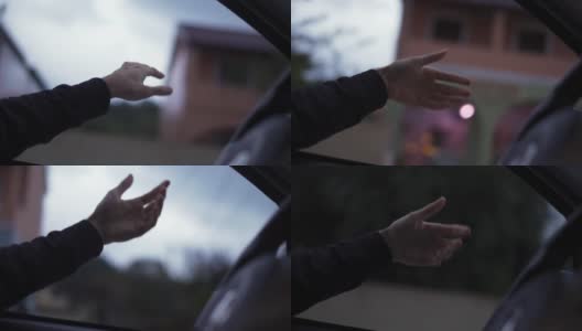 一个男人的手在雨天开车时抓着风高清在线视频素材下载