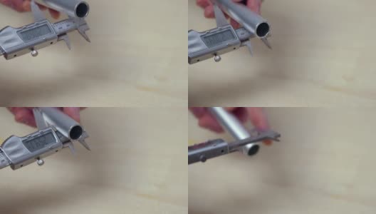 一个人用电子卡尺测量铝管的特写镜头。瑞典。高清在线视频素材下载