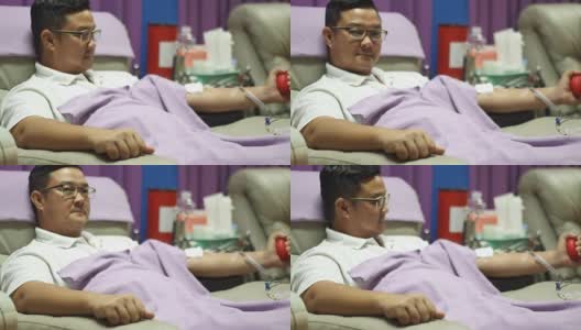一个年轻人在献血的时候，躺在沙发上休息高清在线视频素材下载