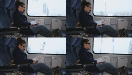 年轻女子在火车上看书高清在线视频素材下载