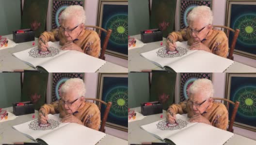 亚裔中国老年妇女在家里用马克笔涂色高清在线视频素材下载