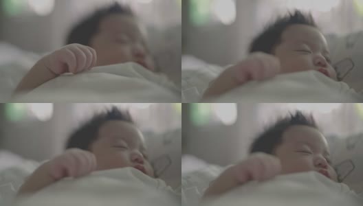 可爱的亚洲新生儿睡觉的特写镜头。高清在线视频素材下载