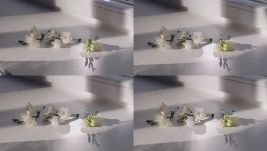 三名婚礼伴娘的白色花束躺在窗台上，在阳光的背光下高清在线视频素材下载