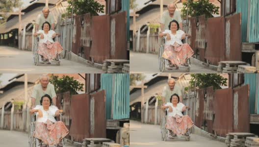 一位老人用轮椅推着她残疾的妻子高清在线视频素材下载