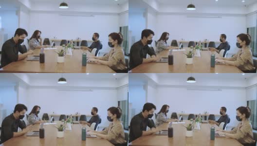 亚洲商务人士戴着口罩在办公室工作高清在线视频素材下载