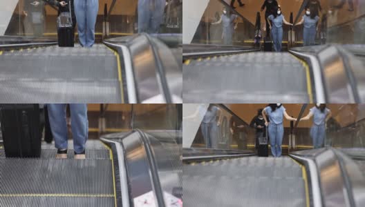 亚洲优雅的商务女士戴着防护口罩，带着行李登上国际机场的自动扶梯。旅行期间大流行。高清在线视频素材下载
