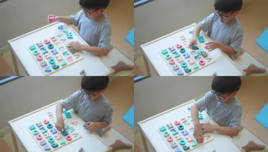 亚洲男孩学习英语字母，玩具和字母表。重返校园的概念高清在线视频素材下载