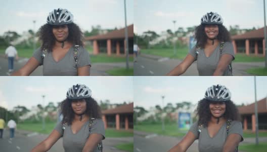 一个黑人女性骑自行车的肖像高清在线视频素材下载