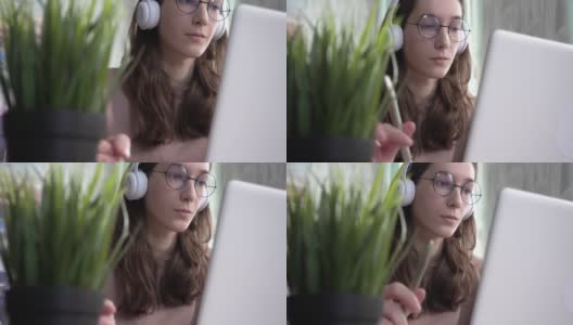 一个女孩在笔记本电脑上做笔记。高清在线视频素材下载