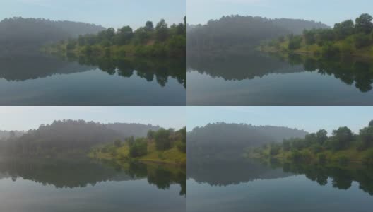 无人机拍摄的湖水和热带雨林。美丽的自然景观和森林的倒影。高清在线视频素材下载