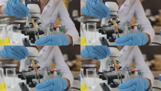 科学家将石蕊试纸放入装有透明液体的试管中高清在线视频素材下载