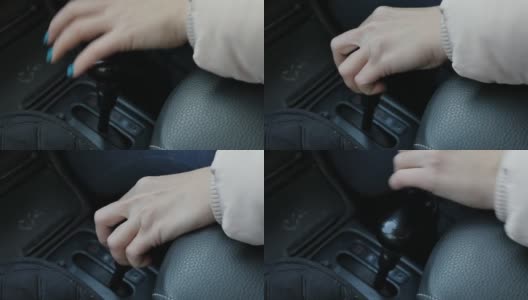 一个有绿色指甲的女人的手在一辆车里开关变速杆高清在线视频素材下载